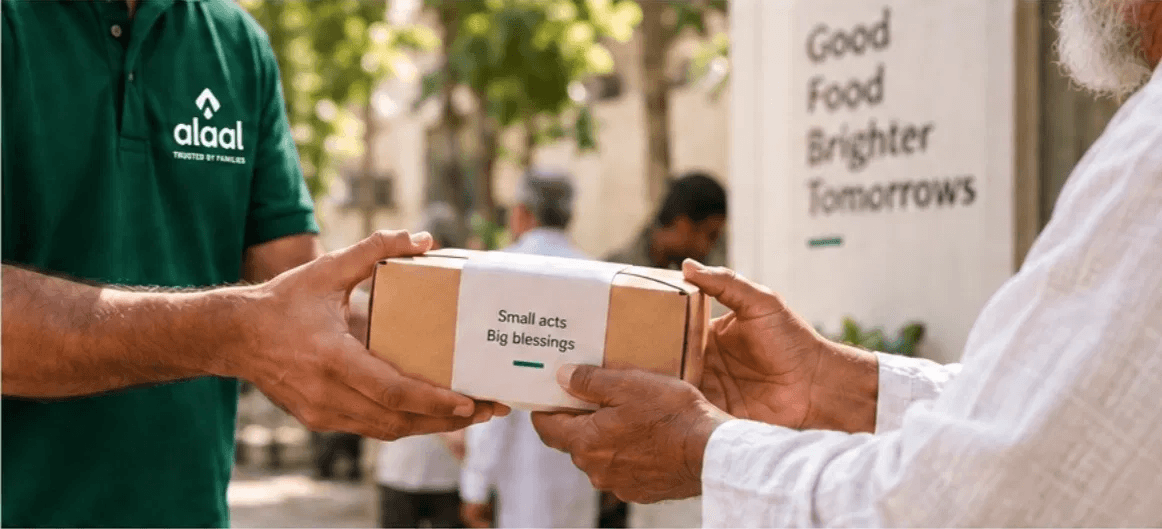 Alaal team handing over a Sadaqah package